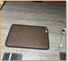 Detail of non-slip backing and vinyl surface on a SunAura heated floor mat