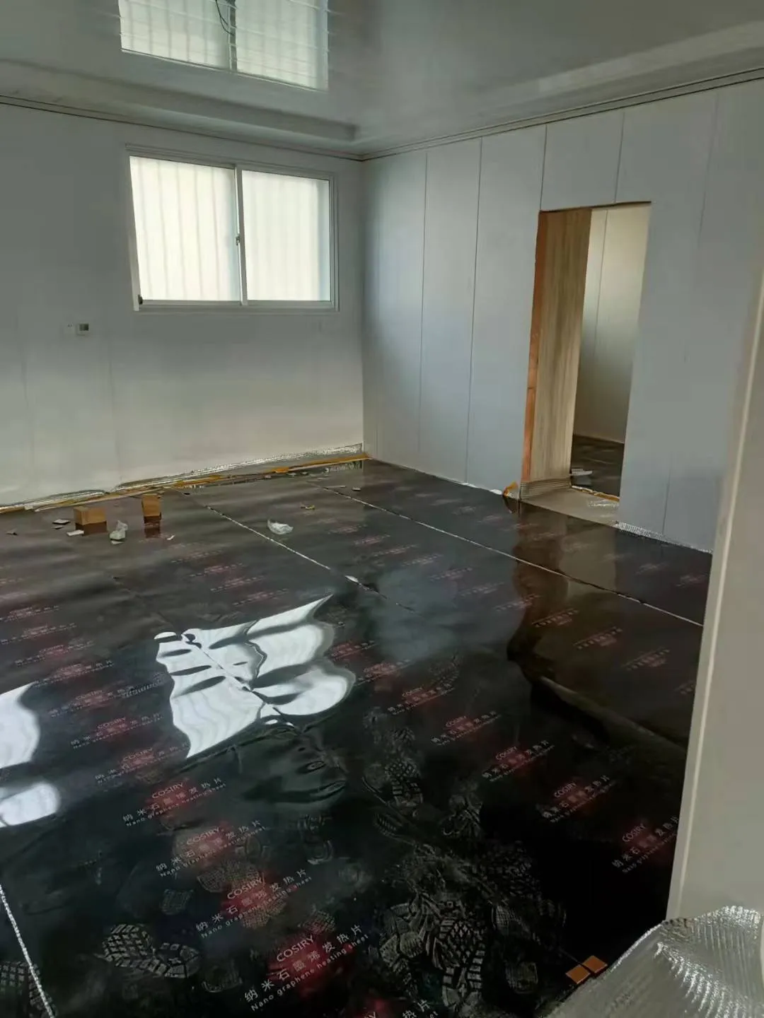 Graphene electric floor heating film installation during home renovation