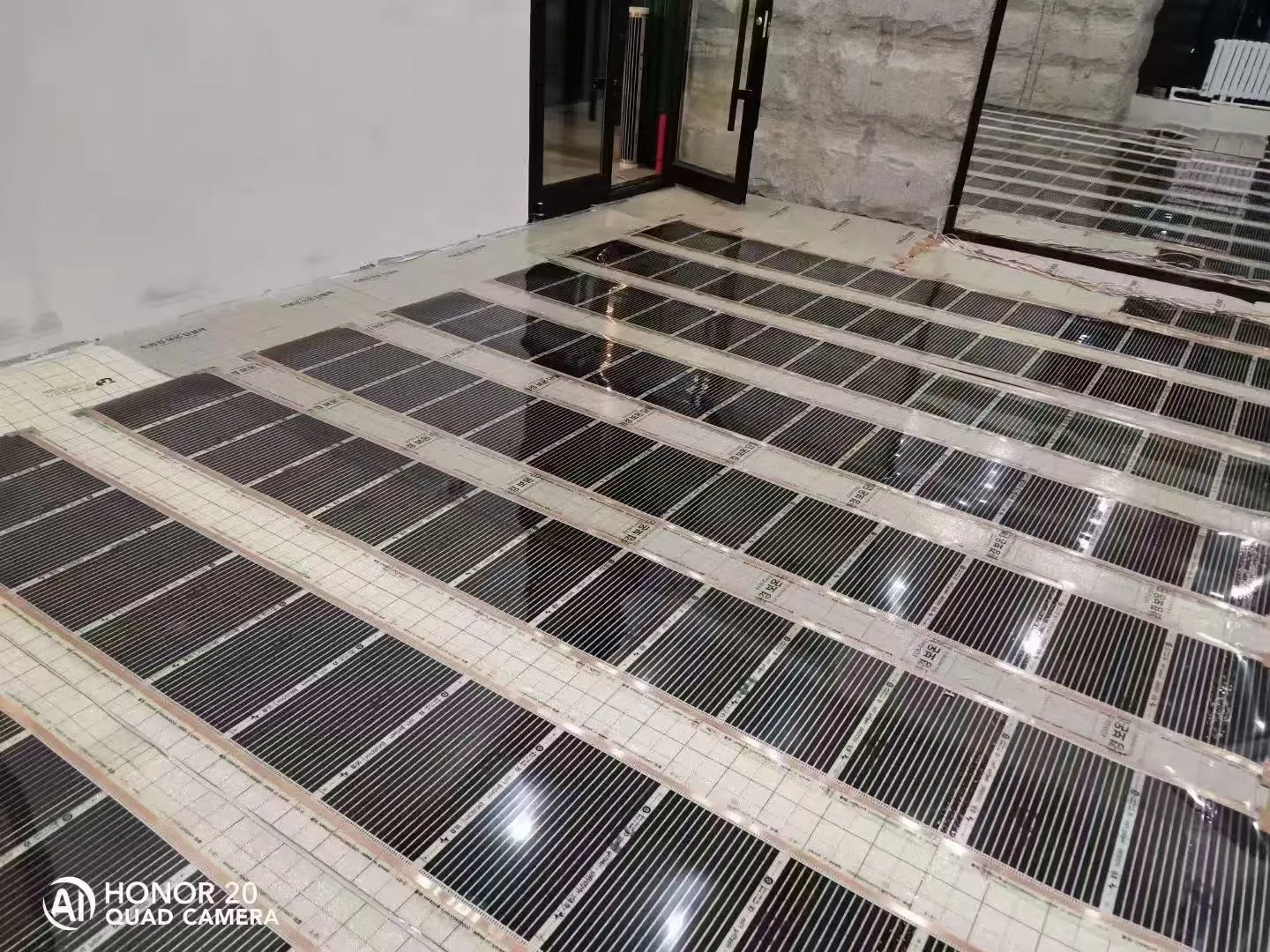 Rows of electric graphene heating film laid on prepared floor substrate